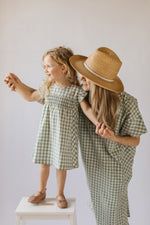 Load image into Gallery viewer, mom and her girl wearing matching check mate patterned dress
