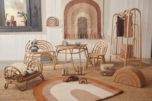 rattan furniture in a kids room styled with rugs