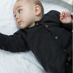 Load image into Gallery viewer, baby in black top with buttons
