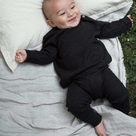 Baby in black legging and black top
